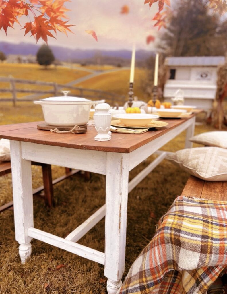 Fall Outdoor Dining Table with fall decorations pumpkins and candlesticks
