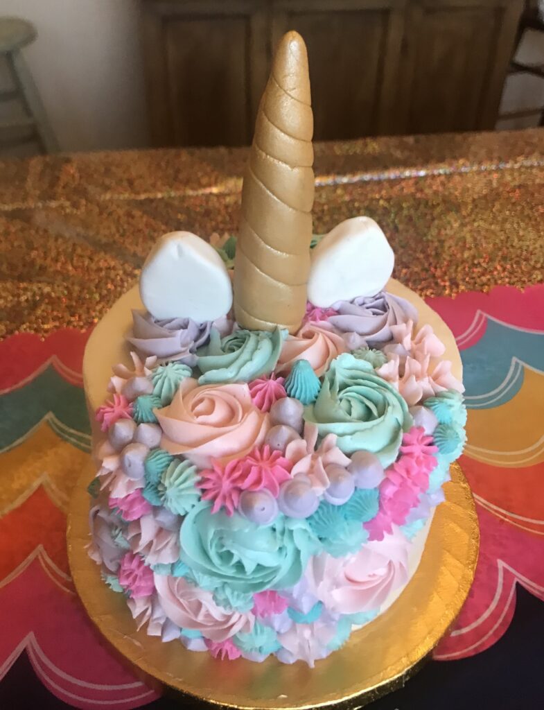 Unicorn horn on pastel colorful cake. Yum@