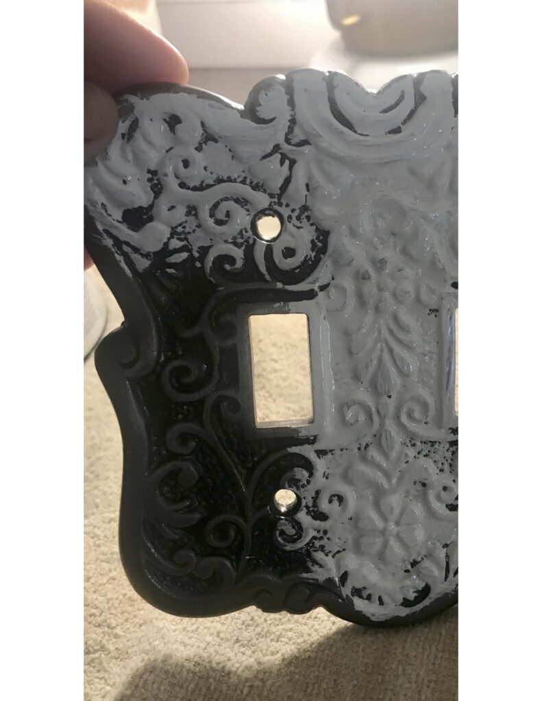Metal vintage inspired switch plate cover being painted 