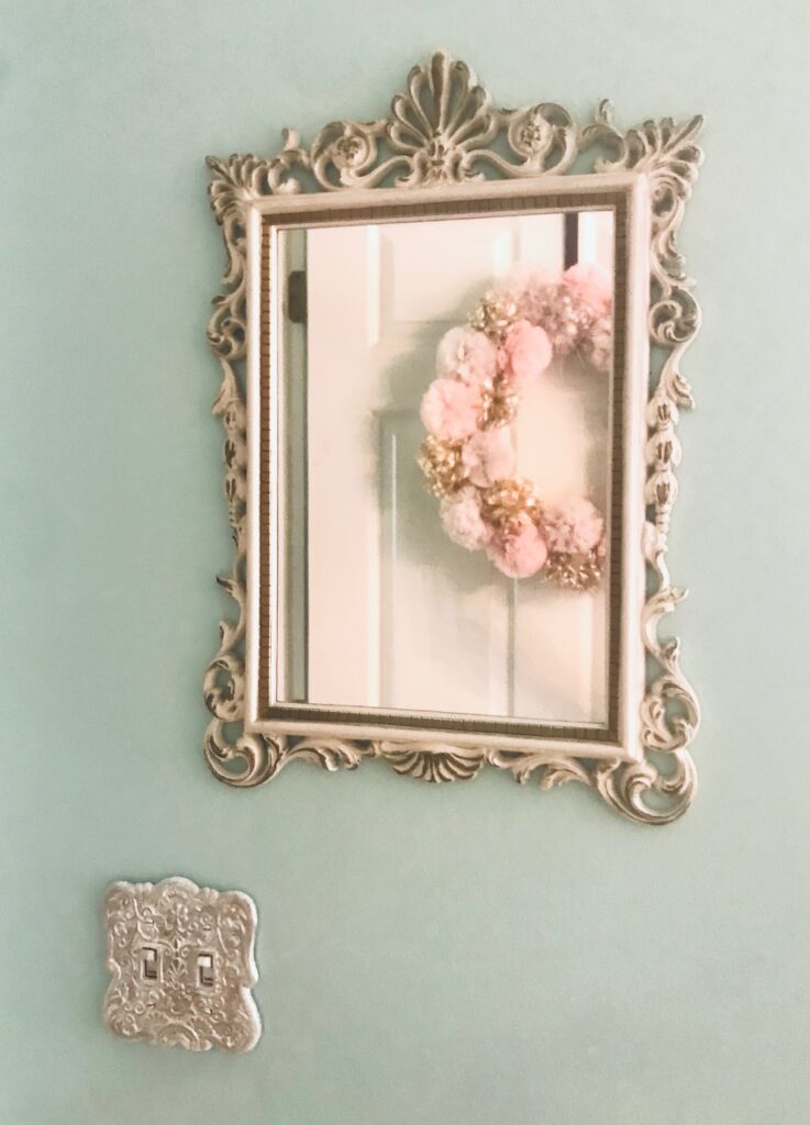 Finished look of the switch plate cover hanging under mirror