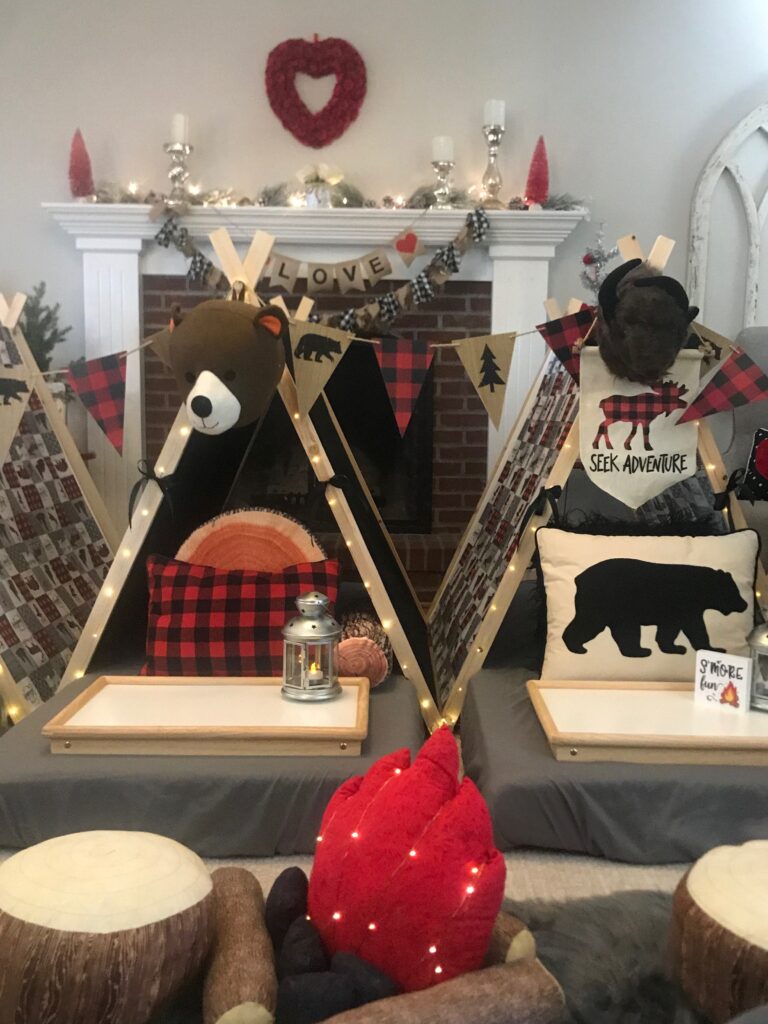 Tents with outdoor camping theme for boys and a faux camp fire.