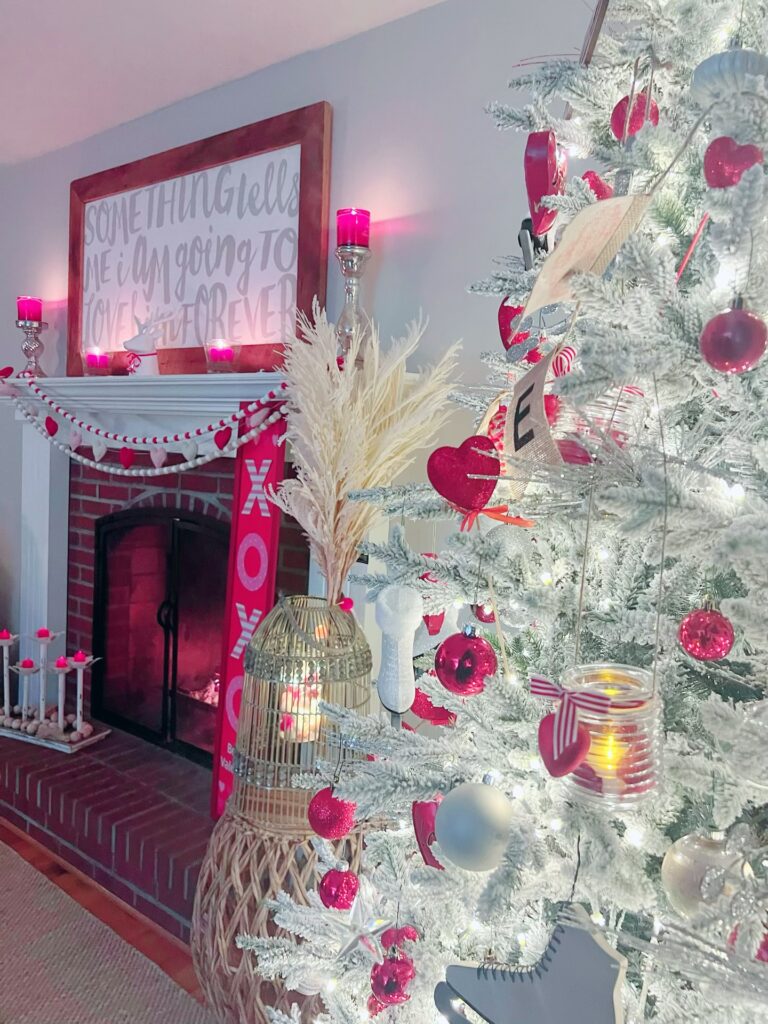 Valentine's Day tree with hearts, and mantle with heart garland, red candles, and XOXO sign.