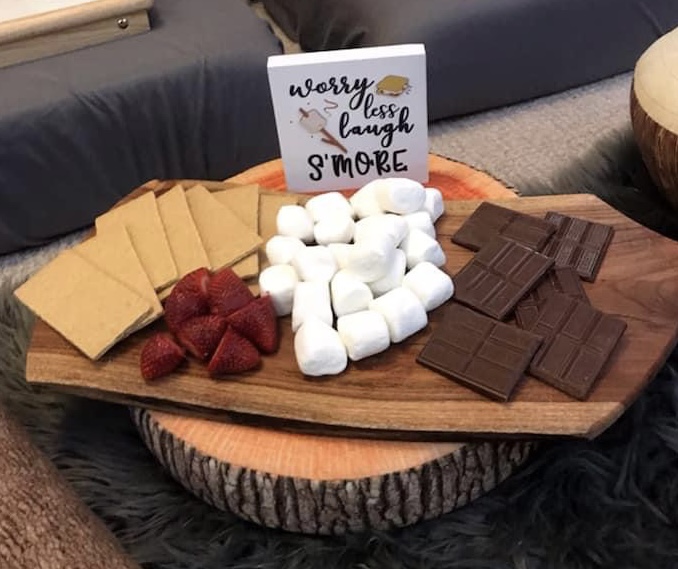 Charcuterie board with marshmellows, graham crackers, chocolate and strawberries