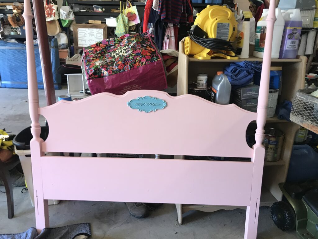 Pink painted headboard with aqua detail.